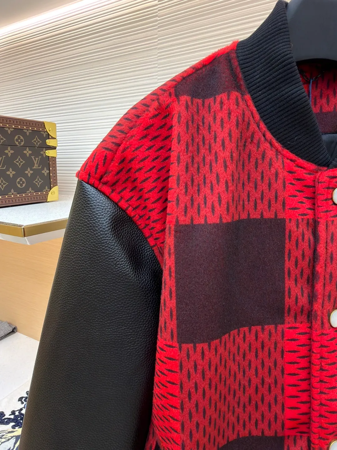 LOUIS VUITTON Plaid Logo Letter Beaded Embroidery Jacket ●Original version: Purchased and developed by 45646 ●Item number: 1681758-B95 ●Fabric: wool blended fabric ●Technology: Beaded embroidery production ●Color: red and black plaid ●Version: Fitted version ●Weight: about 1250 grams ●Size: 46-48-50-52 ●Description: The main body is made of contrasting plaid knitted fabric, with texture levels created through jacquard weaving technology. It is soft to the touch and has a crisp silhouette; the sleeves are spliced with matte leather and treated with scratch-resistant and wear-resistant treatment, giving it both texture and durability. The body of the garment is decorated with the brand's letter logo, using three-dimensional embroidery technology, with bright colors and clear texture to enhance recognition. The version is designed with a fitted baseball collar and is equipped with pearl button closure, making it easy to put on and take off. The ribbed collar, cuffs and hem enhance the fit and take into account windproofness and casual feel. The splicing of the whole garment adopts precision locking technology, with no exposed threads, and the size is measured manually (an error of 1-3CM is normal). The craftsmanship balances the softness of knitting and the toughness of leather, presenting the brand's trendy and advanced style. The overall wiring is straight and delicate, the fabric is comfortable and soft, and the color is consistent without color difference. It can be matched with the same style to create a fashionable look and control various occasions. Customized accessories, complete with three standards, same style for men and women!